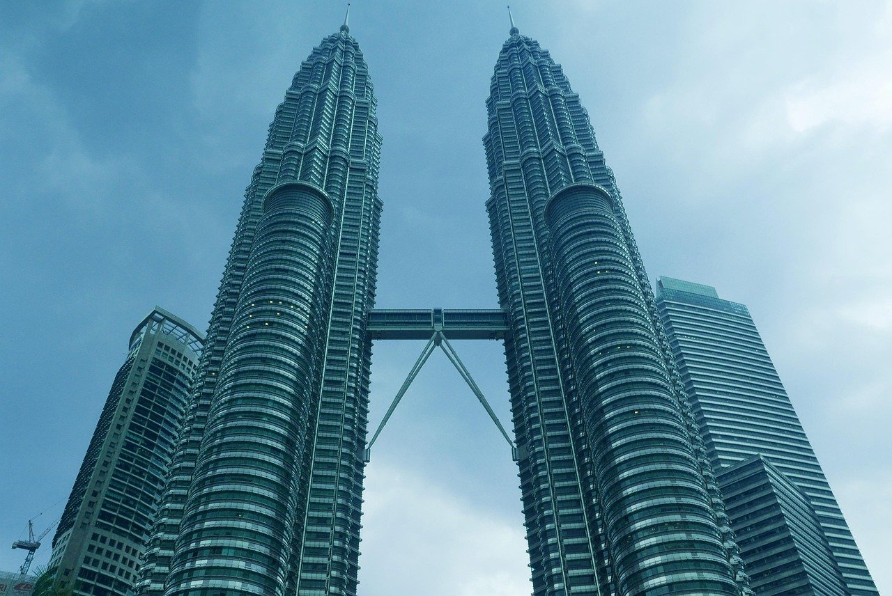Kuala Lumpur skyline at dusk with the Petronas Towers illuminated